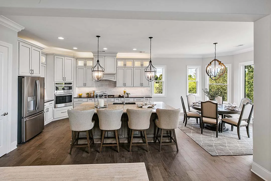 Kitchen with a central island and white cabinetry Kitchen with a central island and white cabinetry