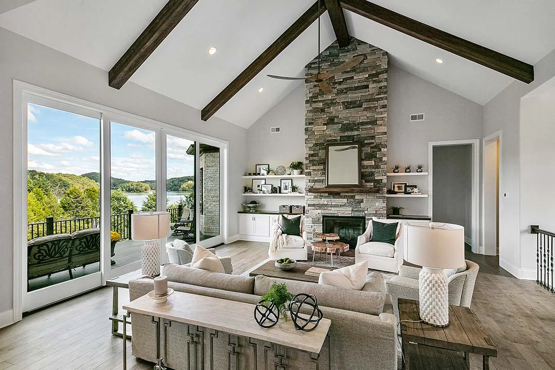 Living room with stone fireplace and ceiling beams Living room with stone fireplace and ceiling beams