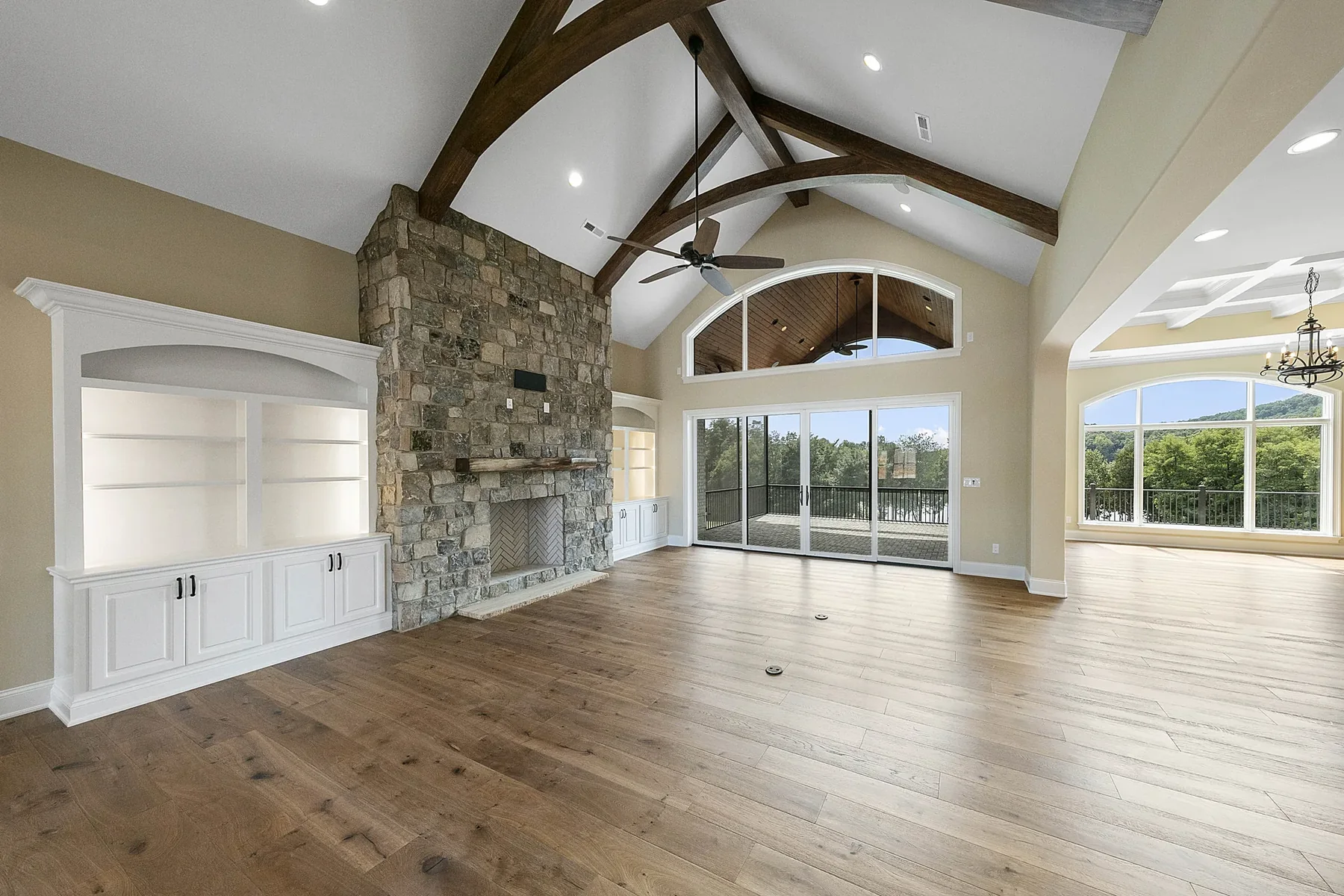 Great room with wood floors and stone fireplace Great room with wood floors and stone fireplace